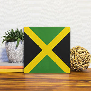 A Slidetile of the The Jamaican Flag sitting on a table.