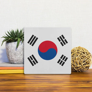 A Slidetile of the The South Korean Flag sitting on a table.