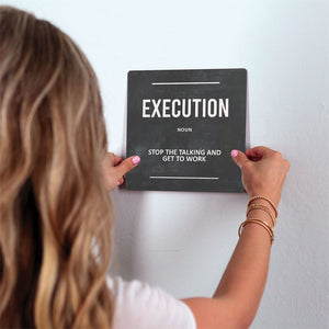 Definition of Execution Slidetile on wall in office.