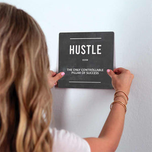 Definition of Hustle Slidetile on wall in office.