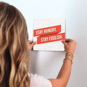 Stay Hungry. Stay Foolish. Slidetile on wall in office.