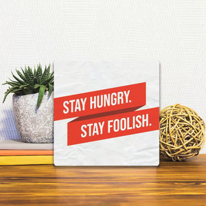 A Slidetile of the Stay Hungry. Stay Foolish. sitting on a table.