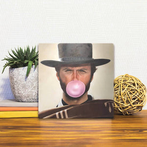 A Slidetile of the Clint Blows a Bubble sitting on a table.