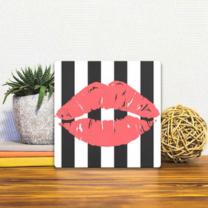 A Slidetile of the Kiss Me sitting on a table.