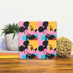 A Slidetile of the Mickey x 4 sitting on a table.