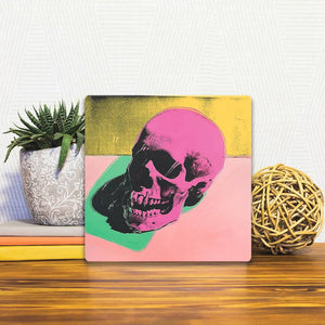 A Slidetile of the Pink Skull sitting on a table.