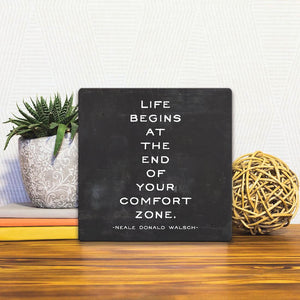 A Slidetile of the At the end of your comfort zone… sitting on a table.