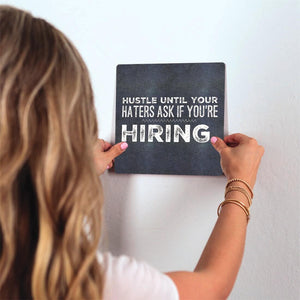 Hustle till your hiring… Slidetile on wall in office.