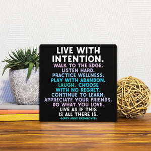 A Slidetile of the Live with intention… sitting on a table.