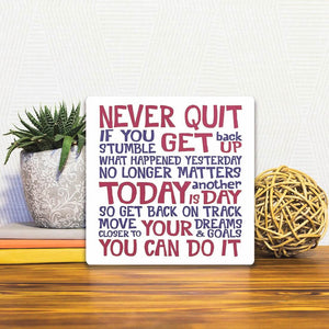 A Slidetile of the Never quit… sitting on a table.