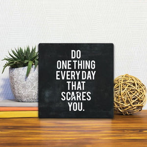 A Slidetile of the Do one thing every day… sitting on a table.