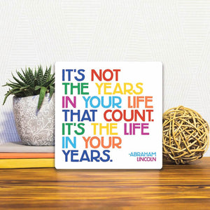 A Slidetile of the It&#39;s not the years in your life… sitting on a table.