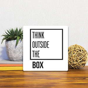 A Slidetile of the Think outside the box sitting on a table.
