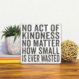 A Slidetile of the Act of Kindness sitting on a table.