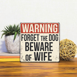 A Slidetile of the Beware of Wife sitting on a table.