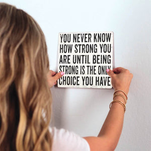 You Never Know How Strong You Are Slidetile on wall in office.