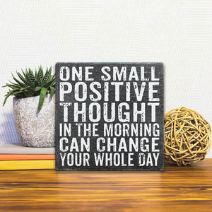 A Slidetile of the One Small Positive Thought sitting on a table.