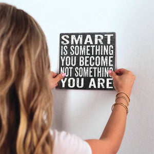 Smart is Something You Become Slidetile on wall in office.