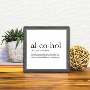 A Slidetile of the Definition of Alcohol sitting on a table.