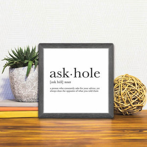 A Slidetile of the Definition of Askhole sitting on a table.