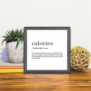 A Slidetile of the Definition of Calories sitting on a table.
