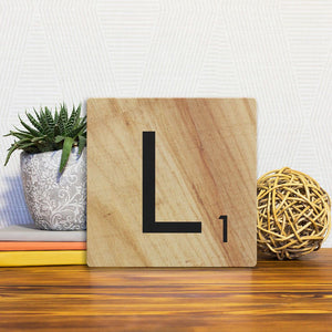 A Slidetile of the Letter L - Light Wood sitting on a table.