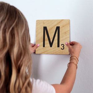 Letter M - Light Wood Slidetile on wall in office.