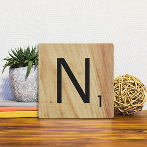 A Slidetile of the Letter N - Light Wood sitting on a table.