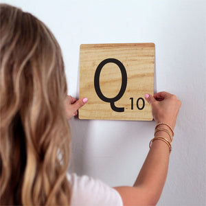 Letter Q - Light Wood Slidetile on wall in office.