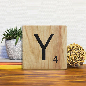 A Slidetile of the Letter Y - Light Wood sitting on a table.