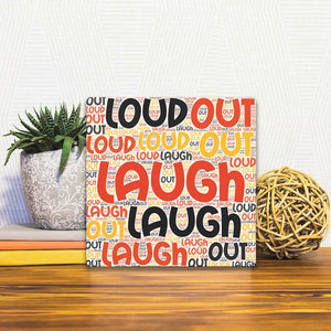 A Slidetile of the Laugh Out Loud sitting on a table.